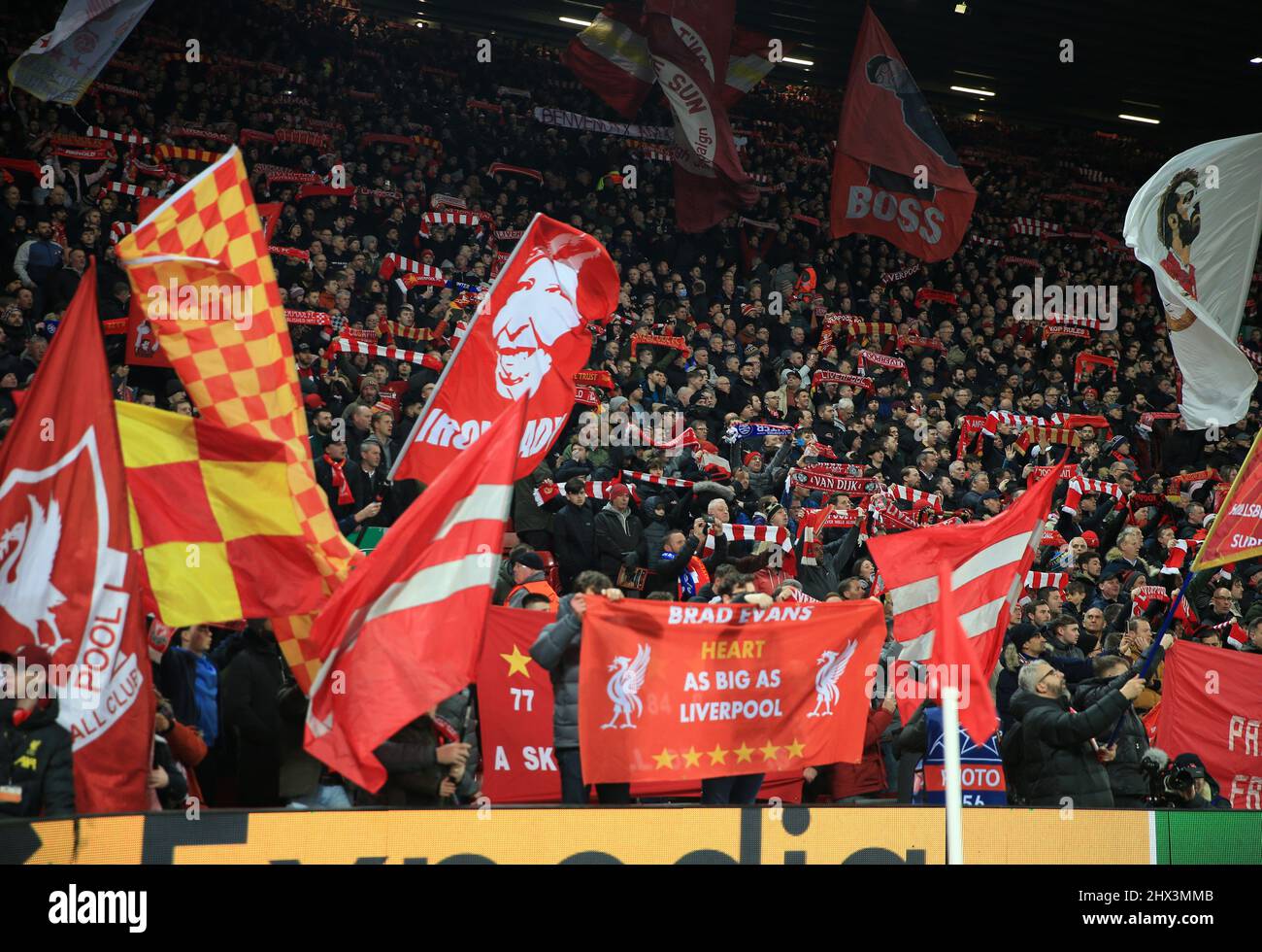 8th March 2022 ; Anfield, Liverpool, England; Champions League football, Liverpool versus Inter Milan : supporters on the Kop wave flags during the singing of You'll Never Walk Alone Stock Photo
