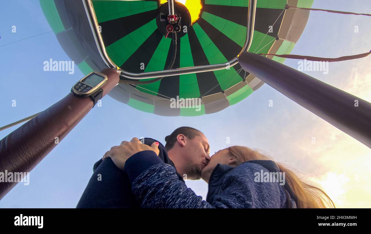 Adventure love couple on hot air balloon watermelon. Man and woman kiss ...