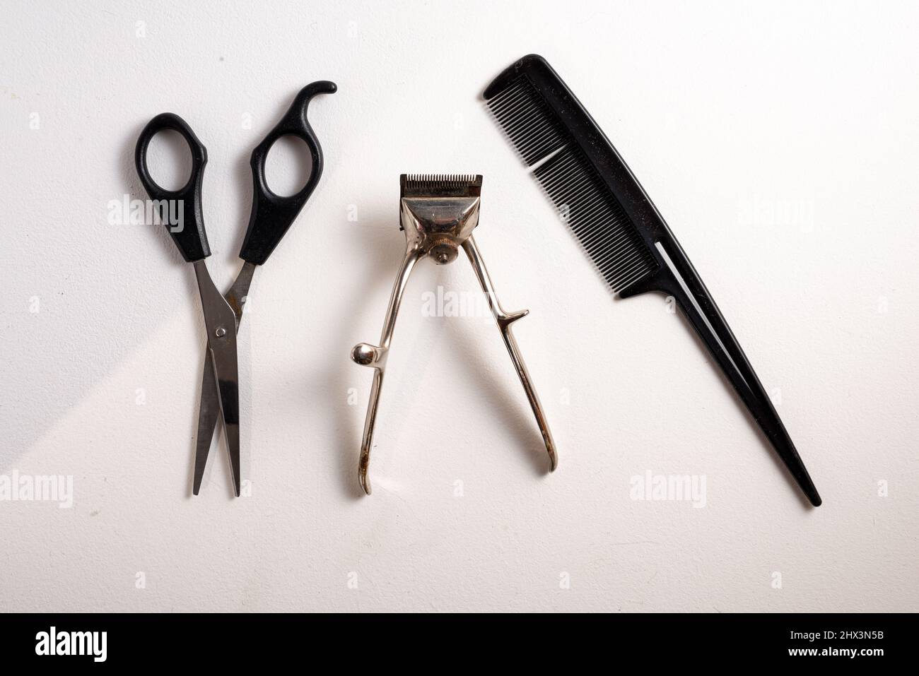 old hair clippers on a white background with scissors and comb ,top view , copy space Stock