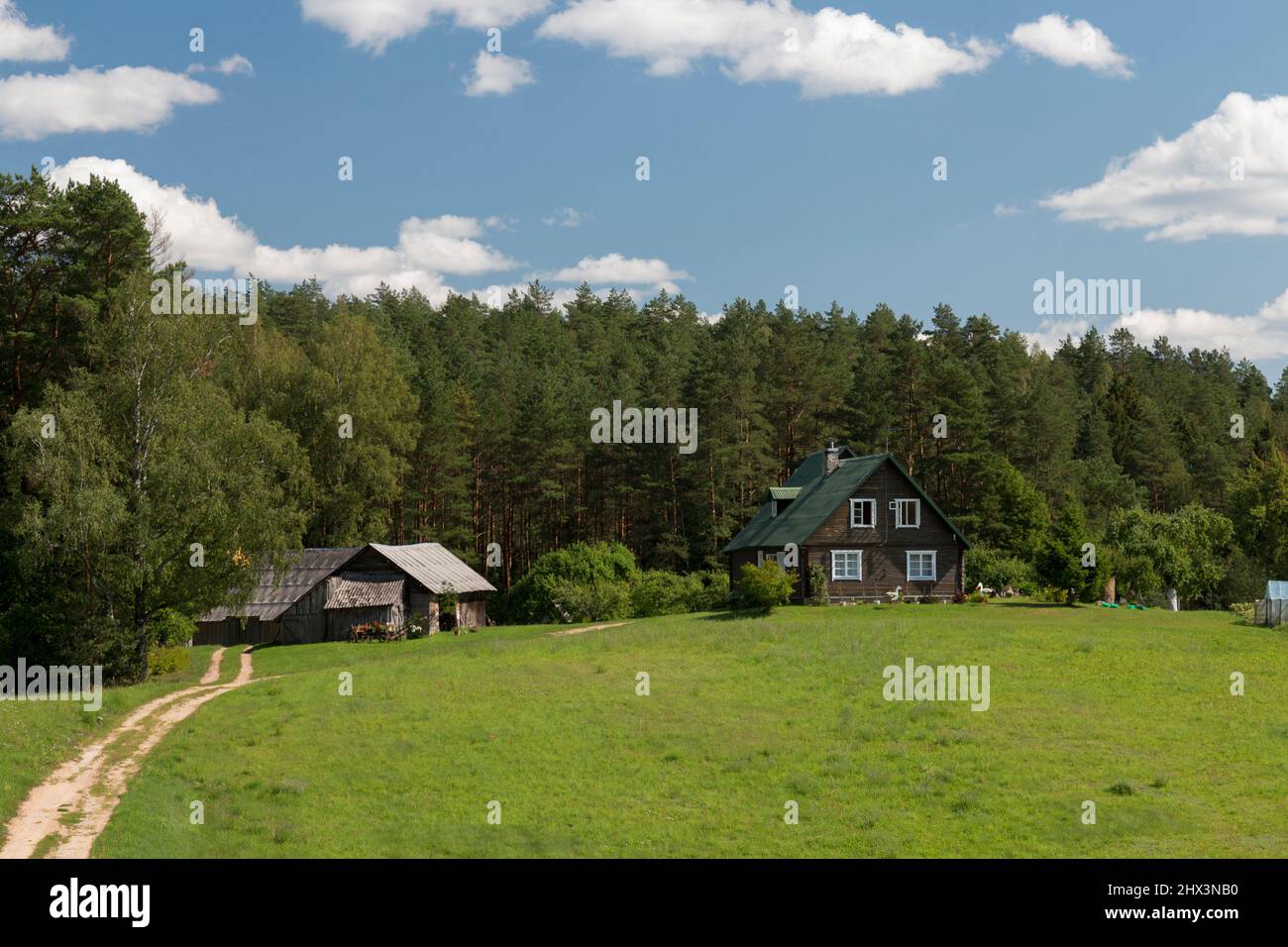 Farmhouse near woodland Stock Photo - Alamy