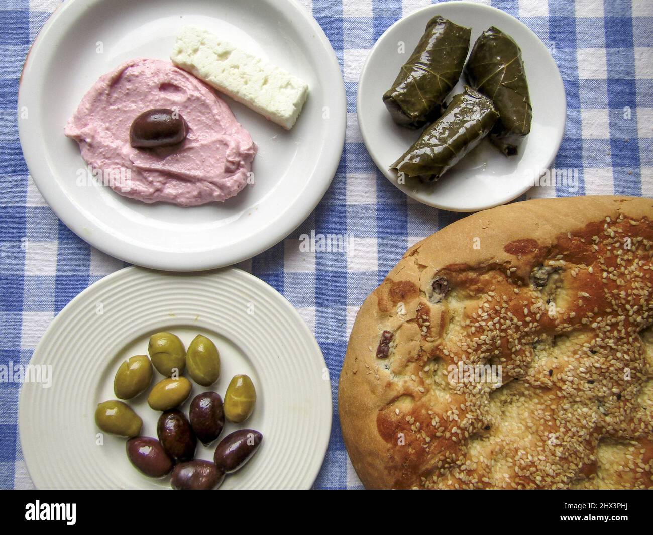 Greek Lent Bread Lagana with Olives, Dolmades, Taramosalata and Feta Stock Photo