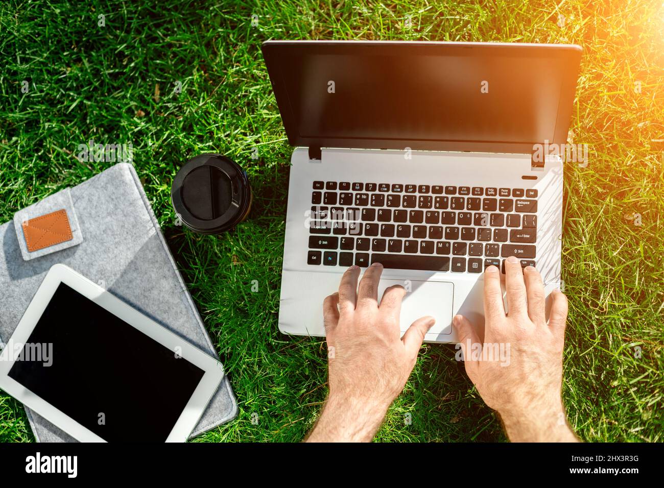 Close-up shot of handsome man's hands touching laptop computer's screen ...