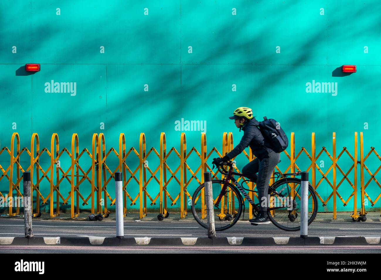 London, UK.  9 March 2022. A cyclist passes between the two 25m long artworks comprising “The Thames Wunderkammer: Tales from Victoria Embankment in Two Parts”, by Simon Roberts commissioned by Tideway.  The work is inspired by landmarks and historical events and is on the hoarding on Victoria Embankment, behind which Tideway is delivering the Thames Tideway Tunnel, a 25km sewer tunnel urgently needed to tackle sewage pollution in the tidal River Thames.  Credit: Stephen Chung / Alamy Live News Stock Photo