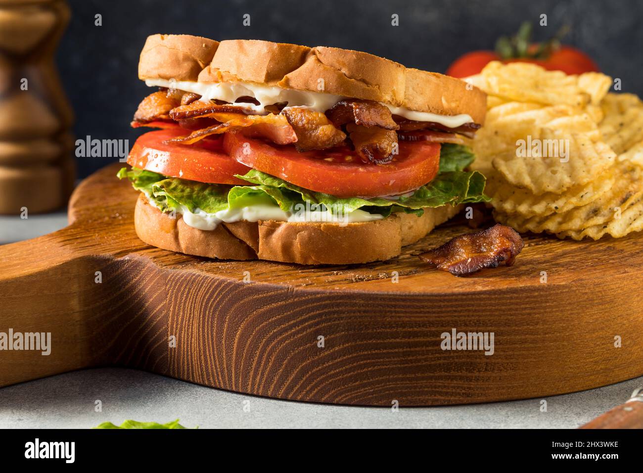 Homemade Bacon Lettuce Tomato BLT Sandwich with Potato Chips Stock