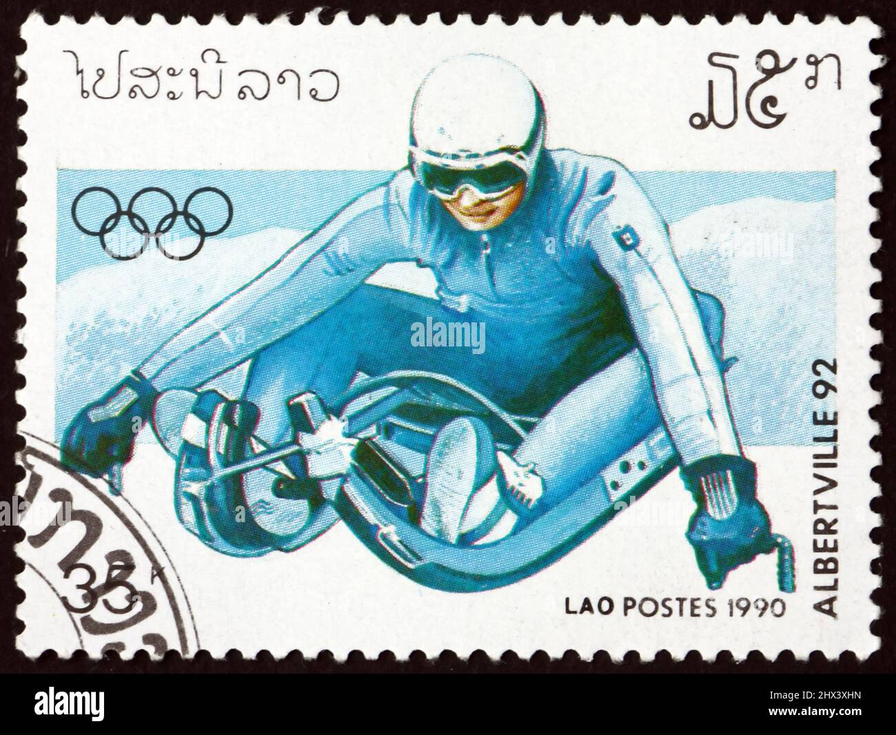https://c8.alamy.com/comp/2HX3XHN/laos-circa-1990-a-stamp-printed-in-laos-shows-luge-1992-winter-olympics-albertville-circa-1990-2HX3XHN.jpg
