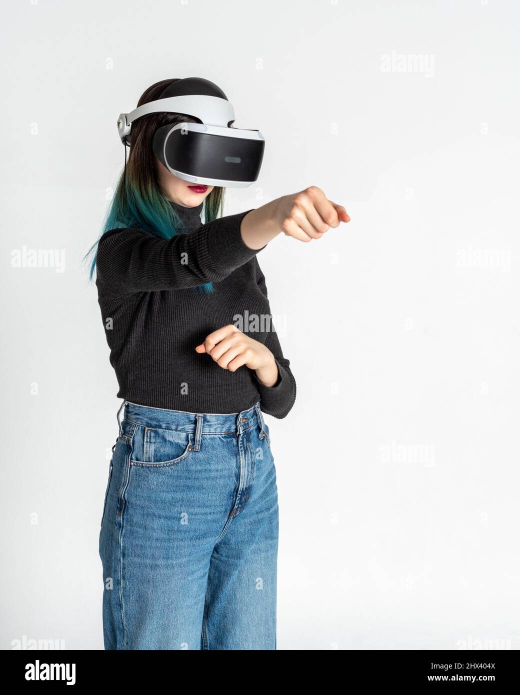 Teenage girl using vr headset punching, fighting with someone in game