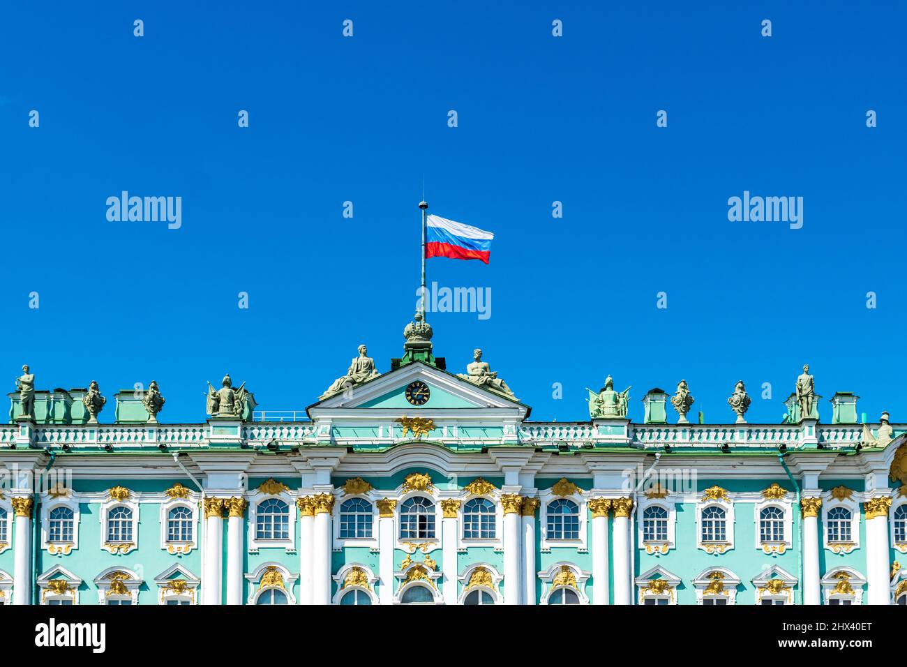 State Hermitage Museum at the Palace Square in Saint Petersburg, Russia, with Russian flag at the top. It's the second-largest art museum in the world Stock Photo