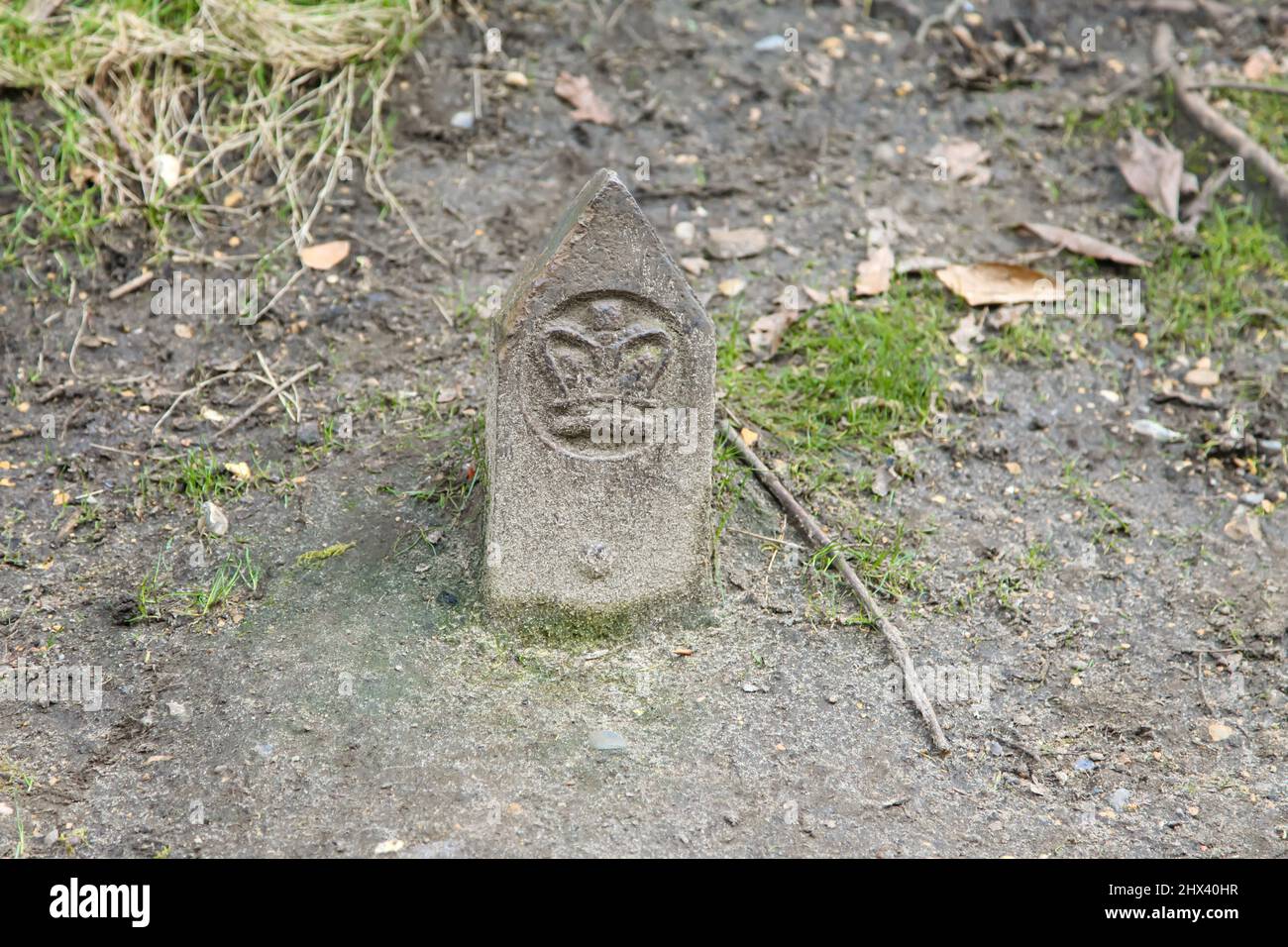 A small stone marker for Crown Estates at Virginia Water Lake, Windsor Great Park, Surrey, March