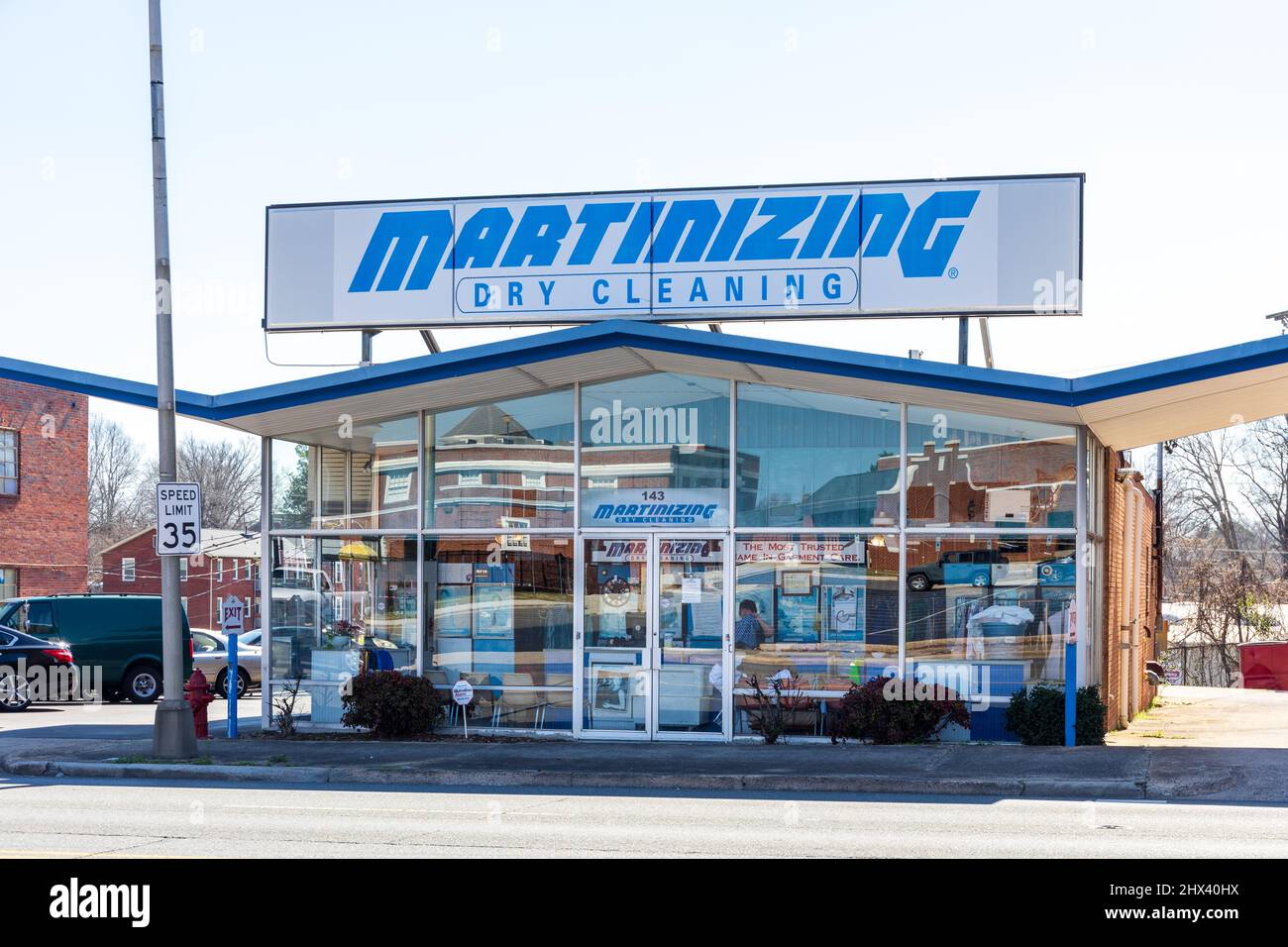 GASTONIA, NC, USA-3 MARCH 2022:  A Martinizing Dry Cleaning center, one of a franchise chain, in nbusiness for over 70 years.  Showing large rooftop s Stock Photo