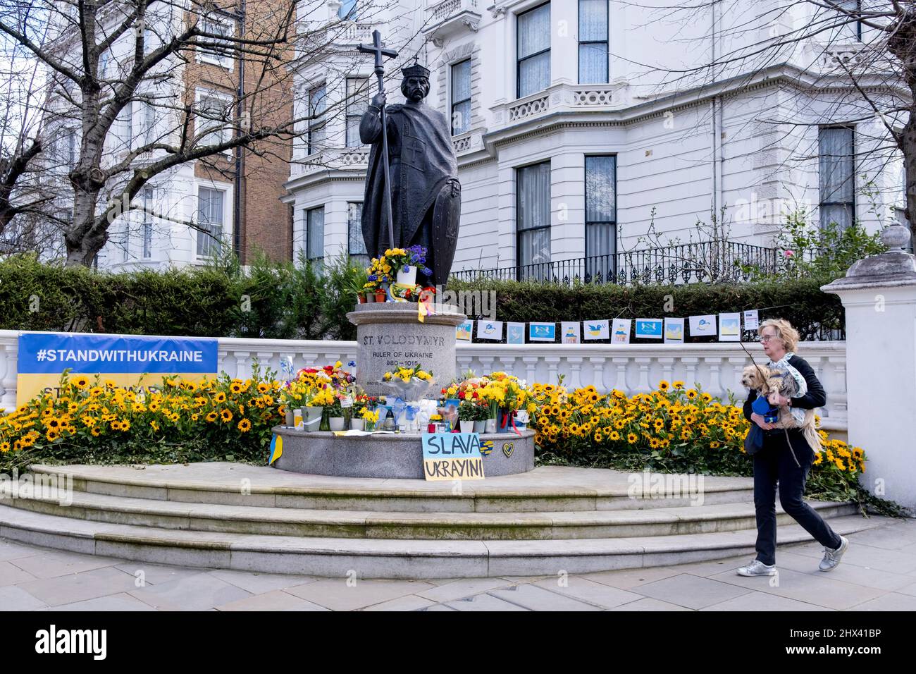 Following Russia’s invasion of Ukraine, flowers and messages are beneath the sculpture of Saint Volodymyr near the Ukrainian Institute in Holland Park, on 9th March 2022, in London, England. Saint Volodymyr was Prince of Novgorod, Grand Prince of Kiev, and ruler of Kievan Rus' from 980 to 1015. Stock Photo