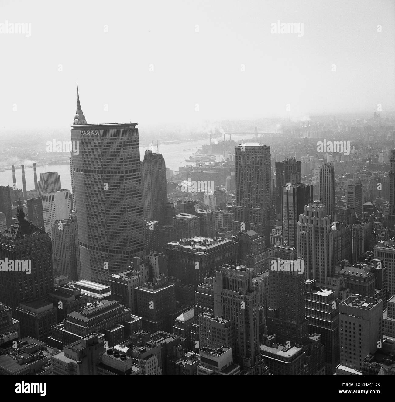 1960s, historical, view across the skyline of New York city, showing the skyscrapers, including the famous Pan Am building and others. In the distance the East river, NY, USA. Built in 1963 in the air space over the terminal of the New Central Railroad, the headquarters of Pan American World Airways was at the time, the largest private office structure in the world. Designed by Emery Roth & Sons, it was 'brutalist' in form. Stock Photo