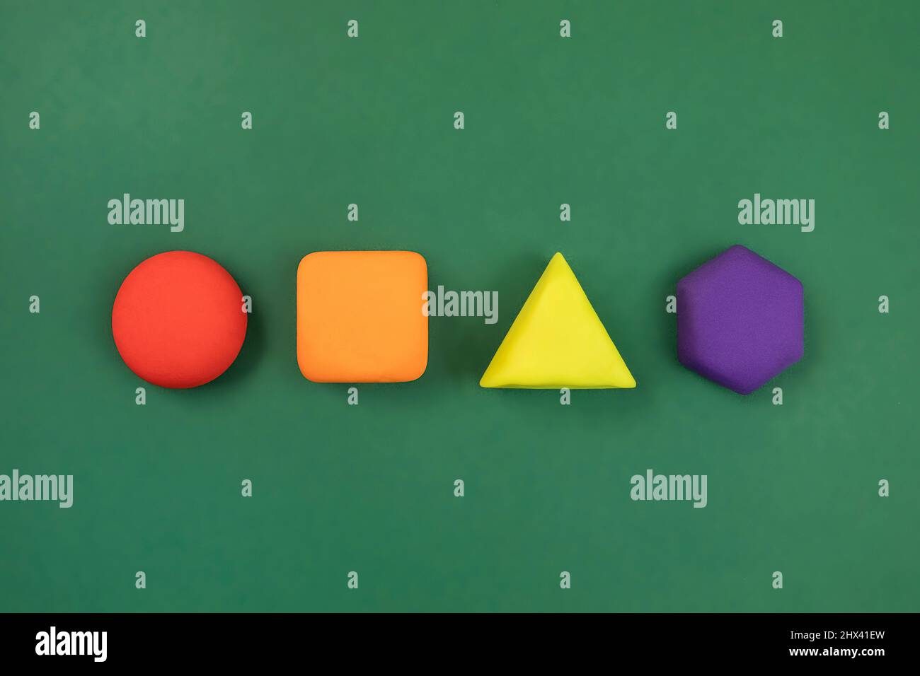 Geometric figures on green background. Colorful circle, square, hexagon