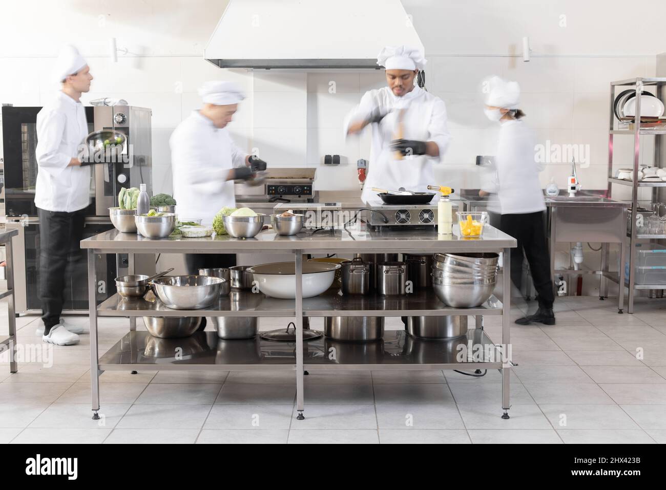 https://c8.alamy.com/comp/2HX423B/chef-cooks-working-in-professional-kitchen-chefs-hurry-up-actively-cooking-meals-for-restaurant-long-exposure-with-motion-blurred-figures-2HX423B.jpg