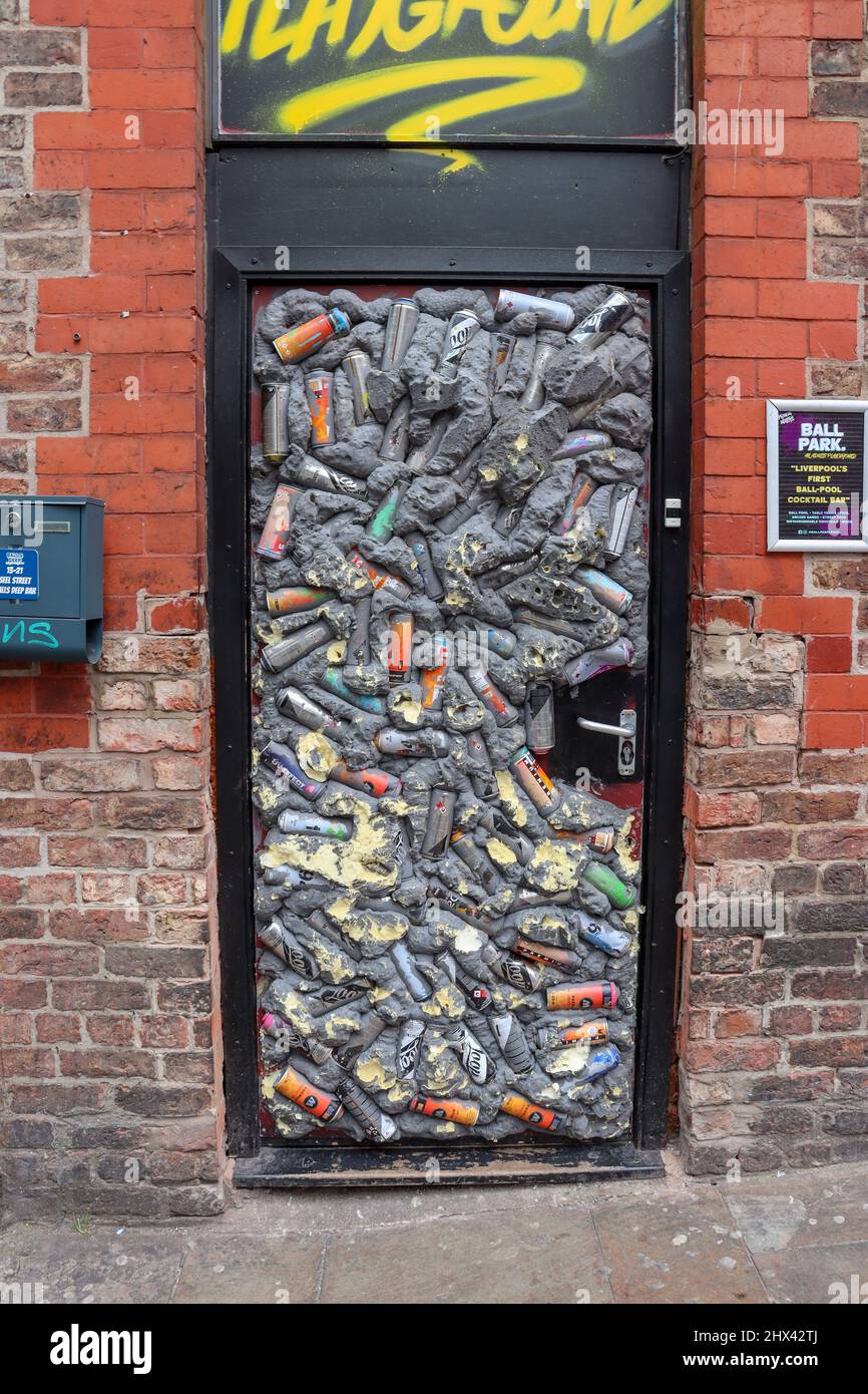 Unconventional door embellished with recycled aluminium beer cans Stock Photo