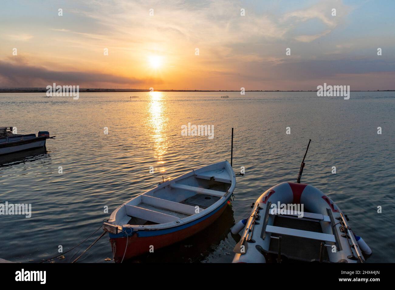 Beautiful background with boats in the lake at sunset Stock Photo - Alamy