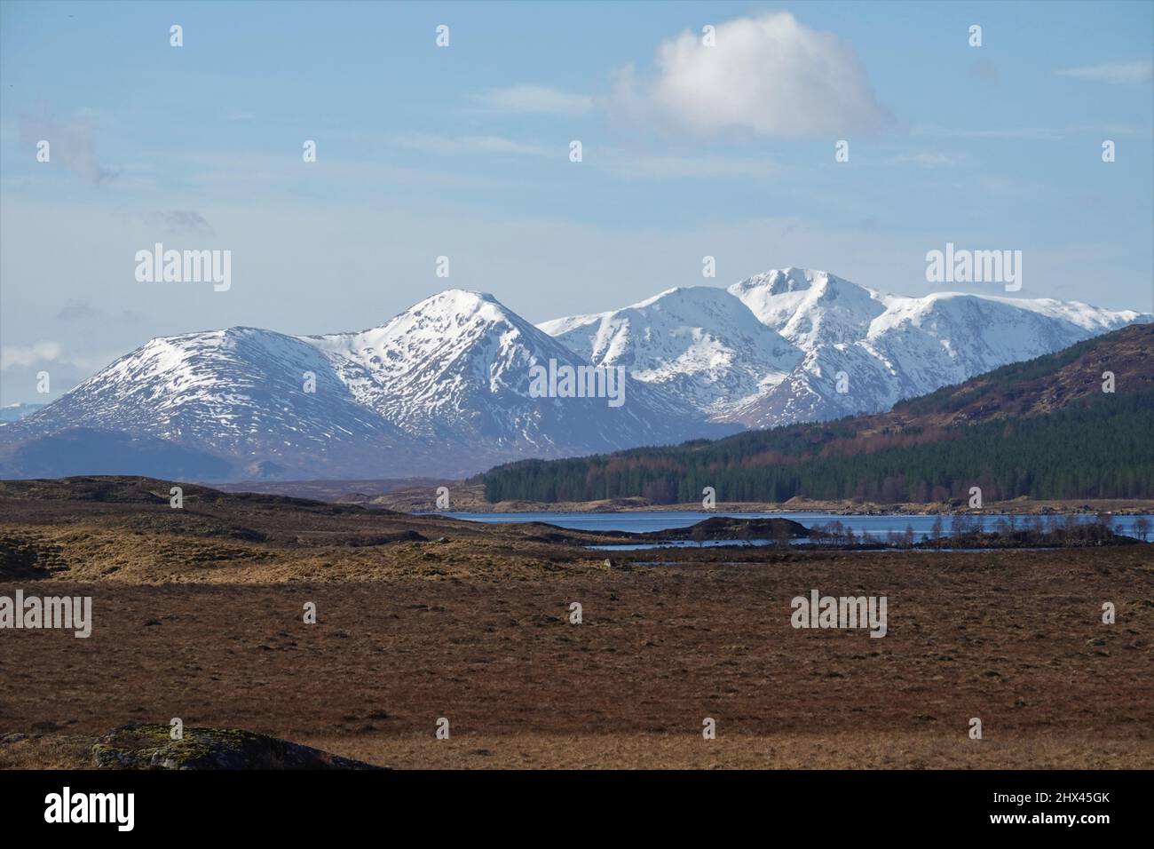 Snow capped mountains of Glen Coe with Loch Laidon in the foreground, Scotland, United Kingdom Stock Photo