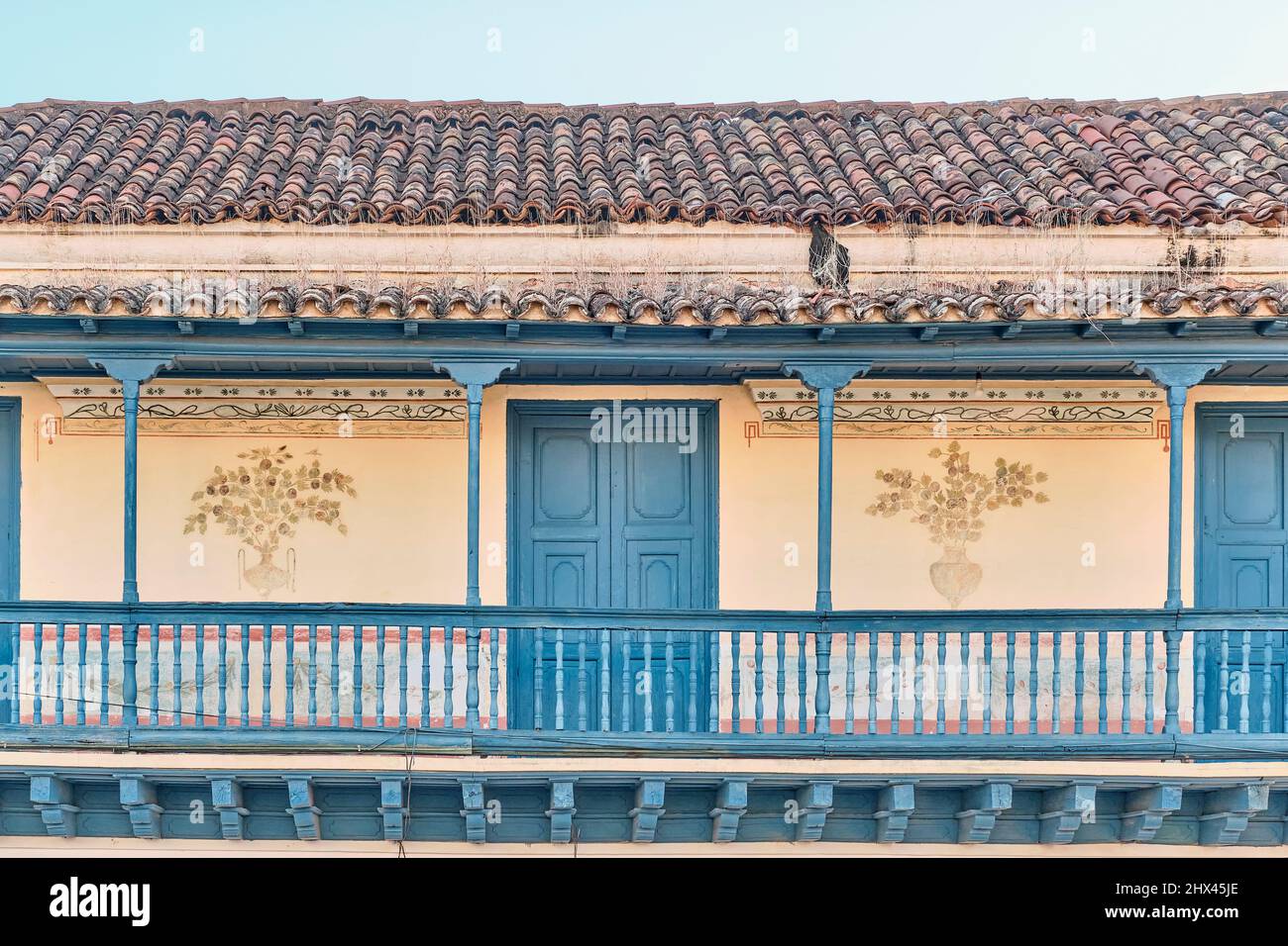Big balcony with wooden railings of colonial Spanish style house in
