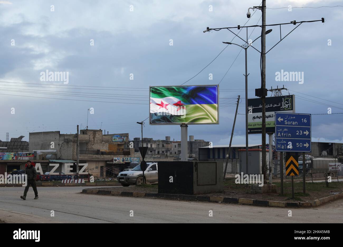 An electronic billboard depicting flags of Syrian opposition and Ukraine, in support of Ukraine amid Russia's invasion, is seen in the rebel-held city of Azaz, Syria March 9, 2022. REUTERS/Khalil Ashawi Stock Photo
