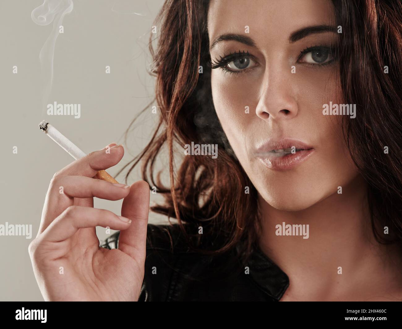 bad girl smoking Shes a bad girl by nature. Portrait of an attractive young woman smoking a  cigarette Stock Photo - Alamy