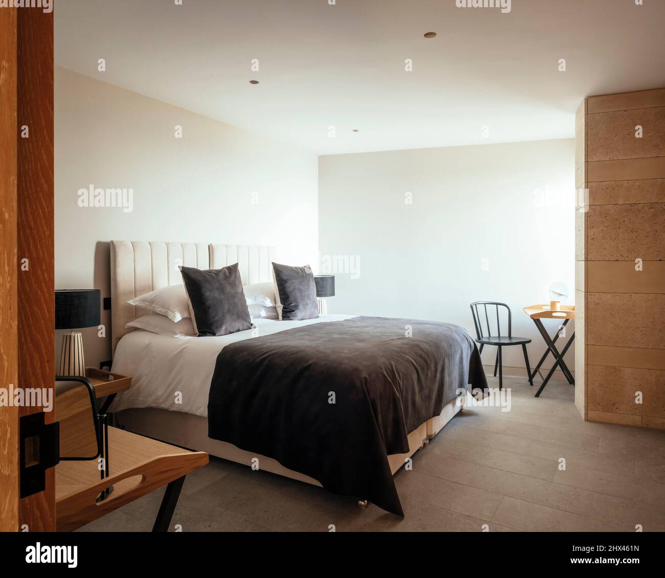 Interior view of lodge bedroom, with polished stone wall detail