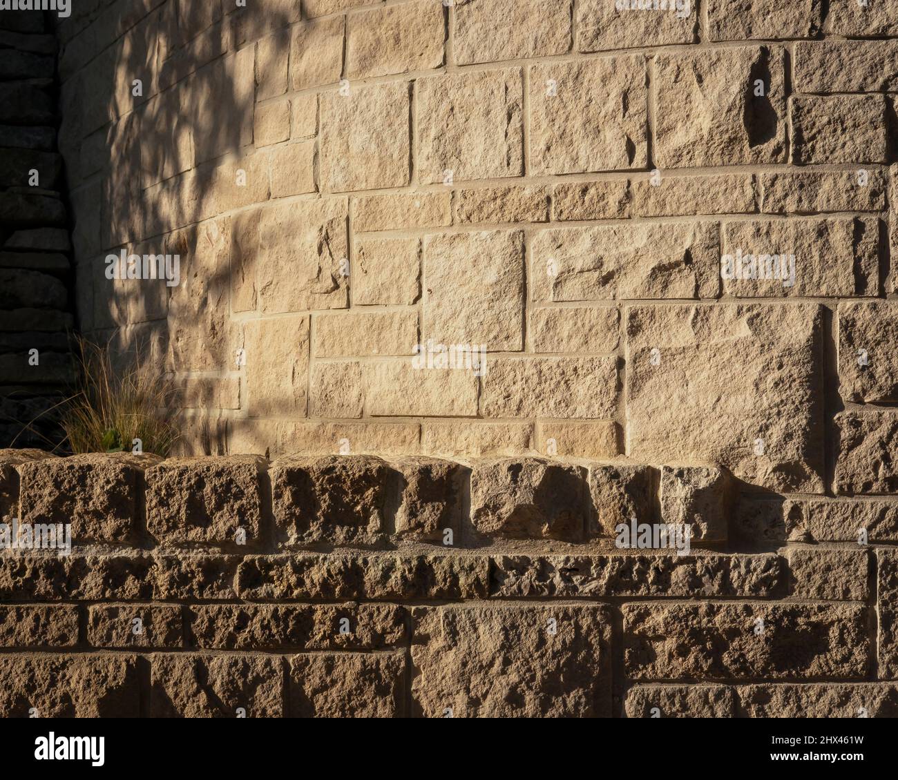 Exterior detail of the join and transition between rough stone walls