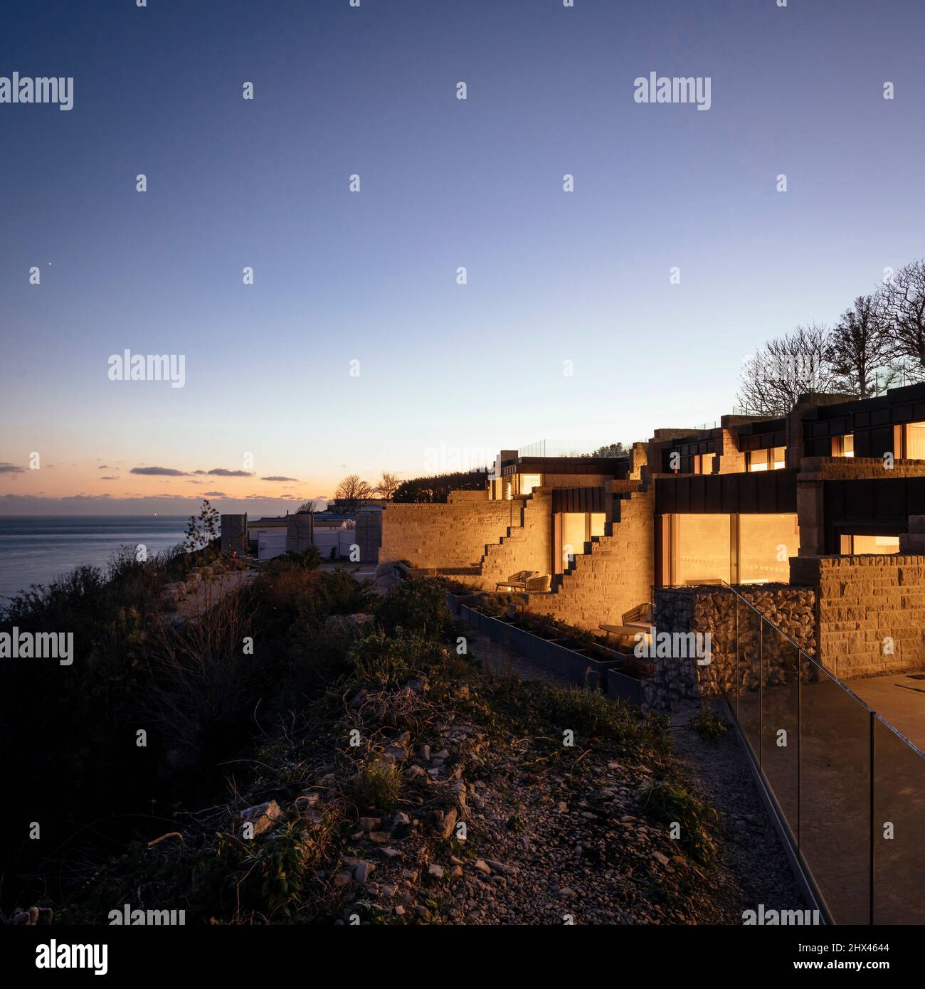 Dusk exterior, aerial view of illuminated windows and private seating