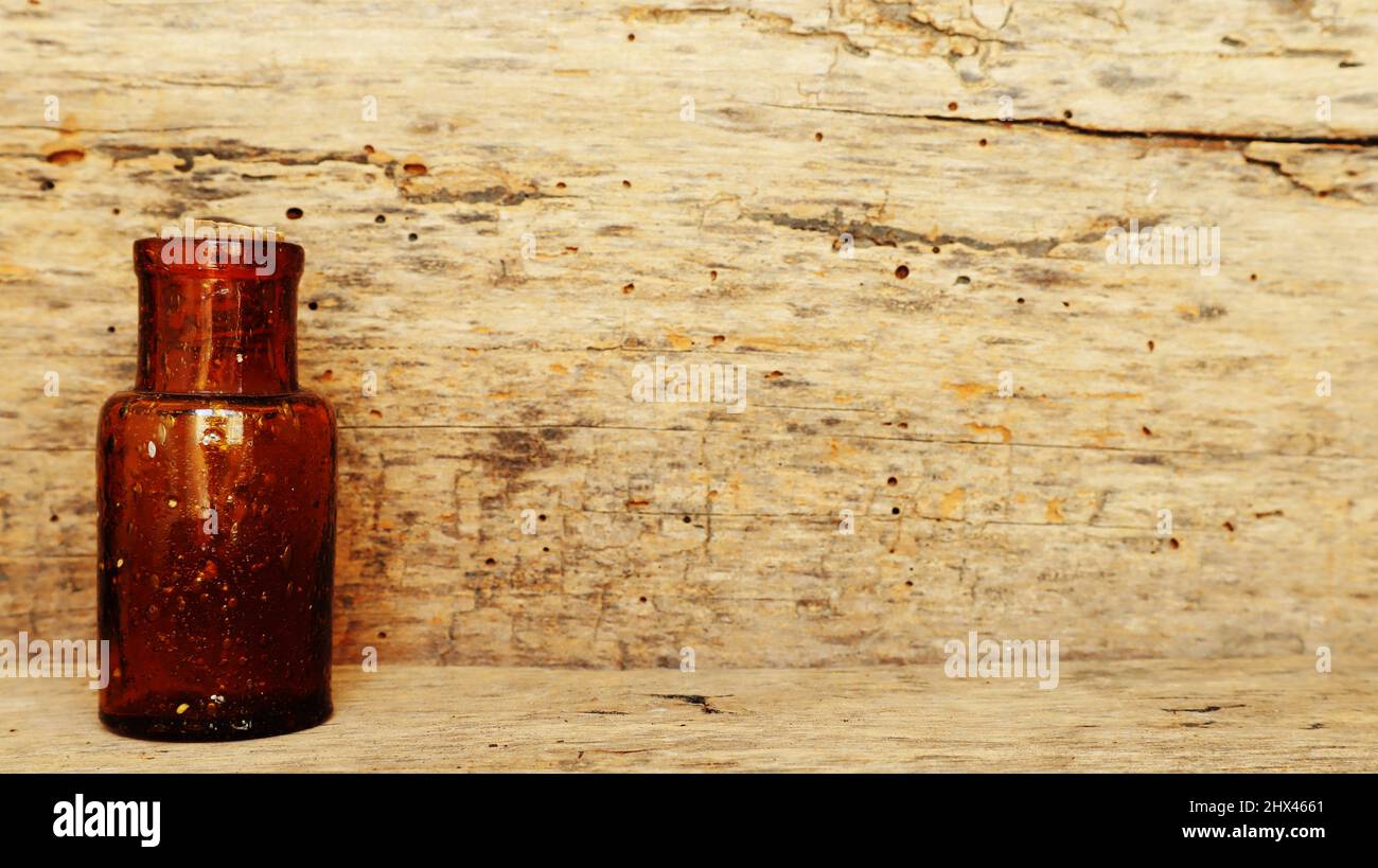 Antique Medicine Bottle, Victorian Era, on a original 1800s wooden background with space for your text or design Stock Photo