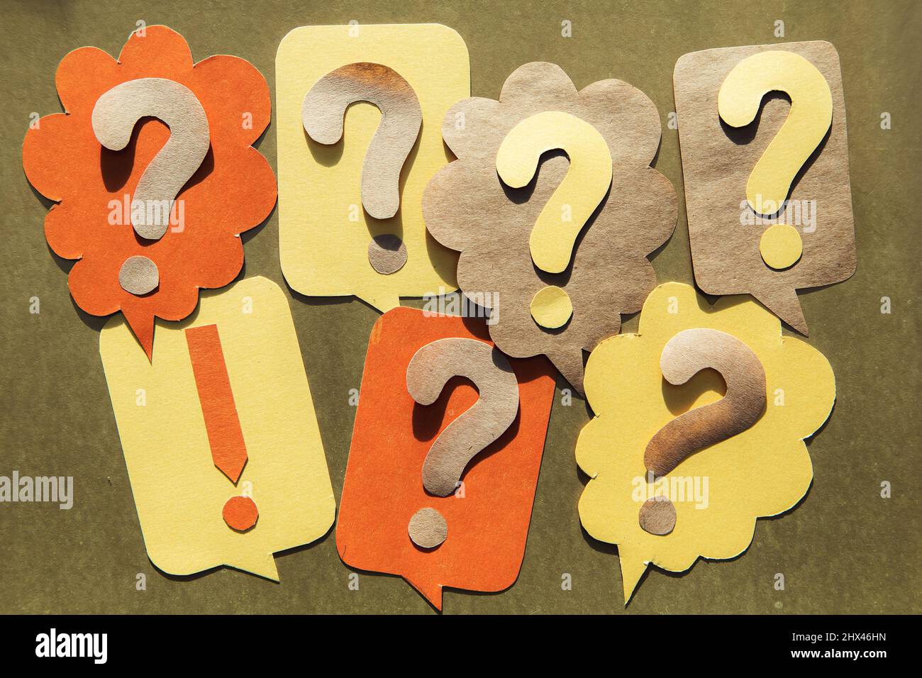 Question mark on speech bubbles, golden background. View from above. Problem and solution concept. Brainstorm. Stock Photo
