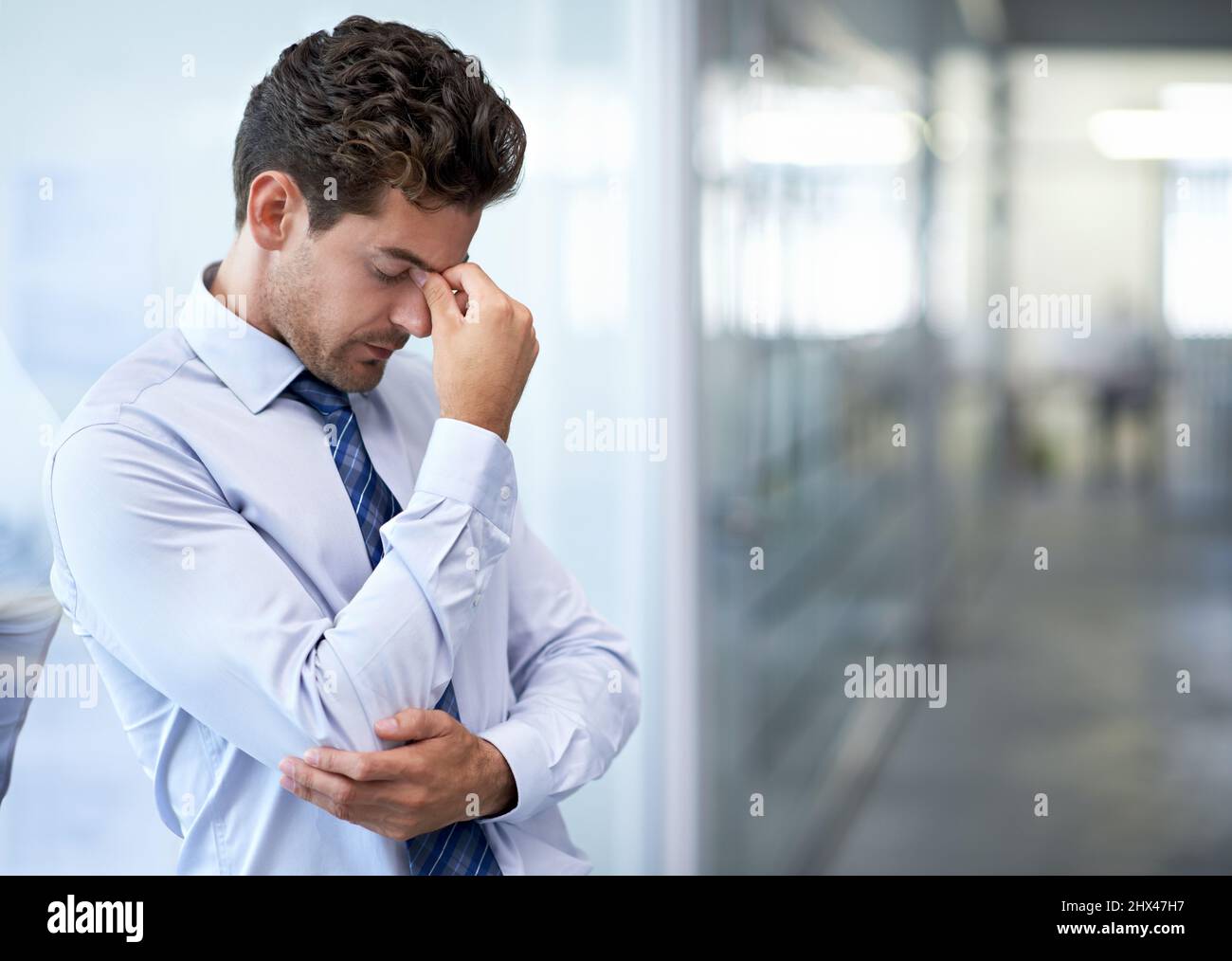 The pressure is just crazy. A young businessman looking stressed-out at the office. Stock Photo