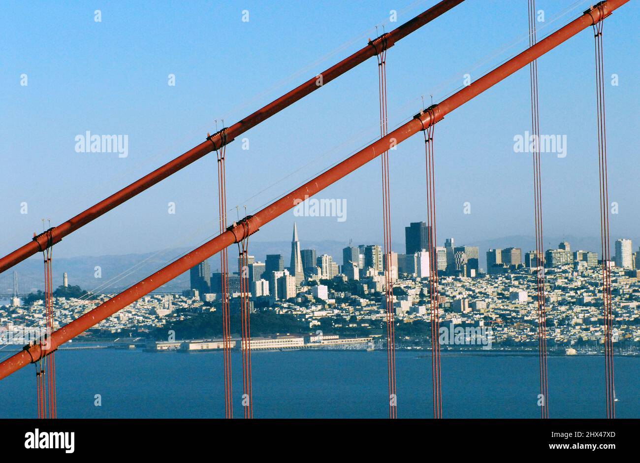 A unique view of beautiful San Francisco through the suspension cables of the famous Golden Gate Bridge. Stock Photo