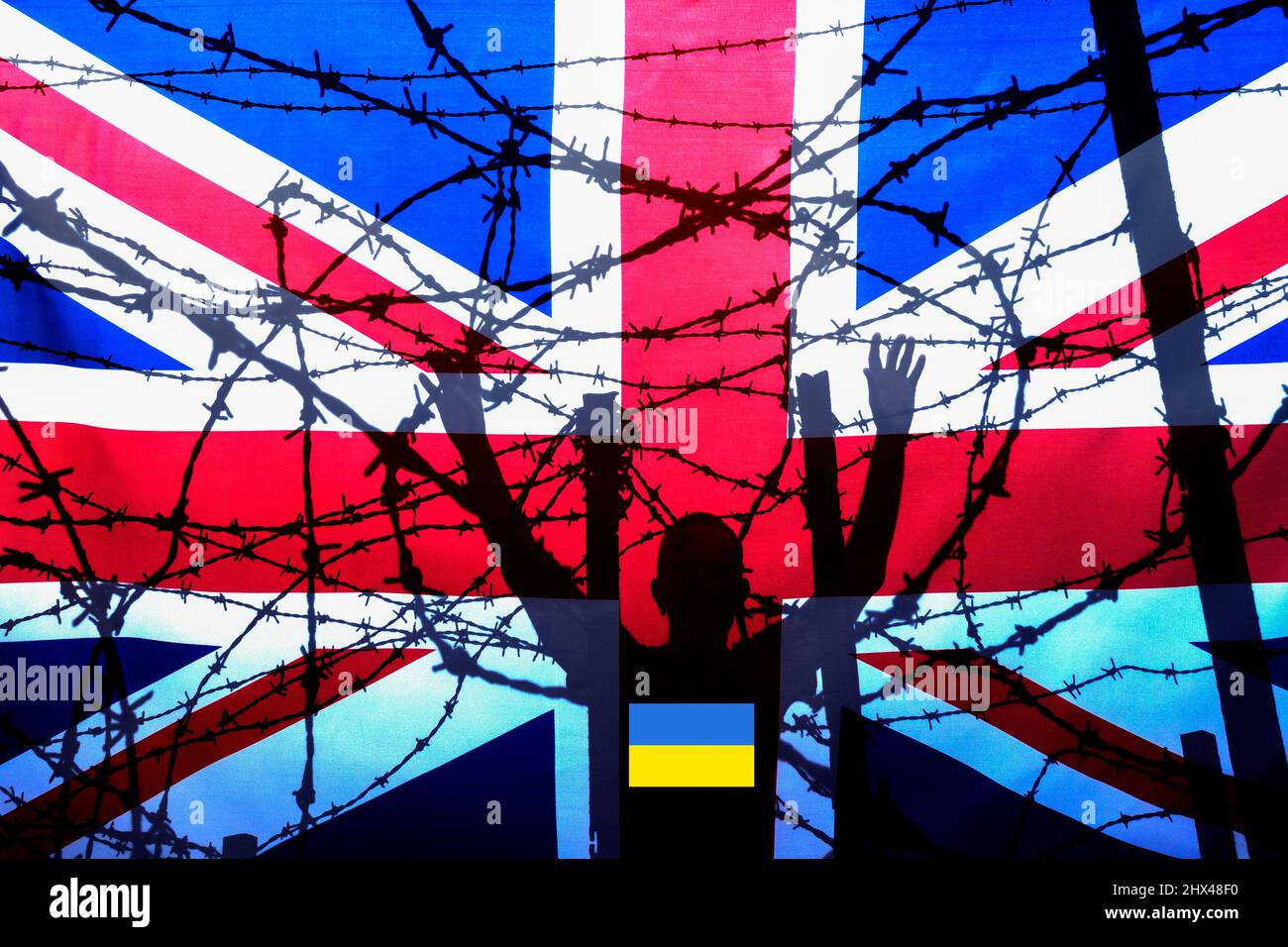 Man at border fence control with UK flag. Ukraine flag on shirt. UK immigration, visa policy, Ukraine, Russia conflict refugee, Brexit, EU border.. Stock Photo