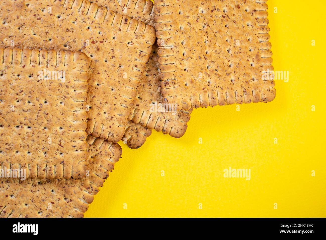 Rye biscuits, close up on yellow background Stock Photo
