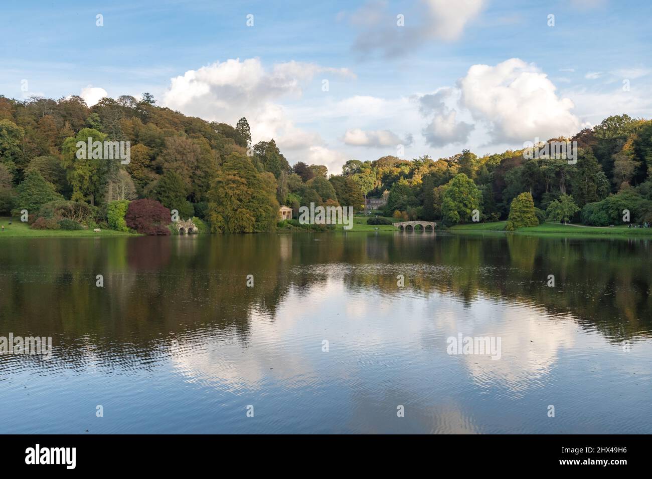 View of the autumn colours around the lake at Stourhead gardens in Wiltshire Stock Photo