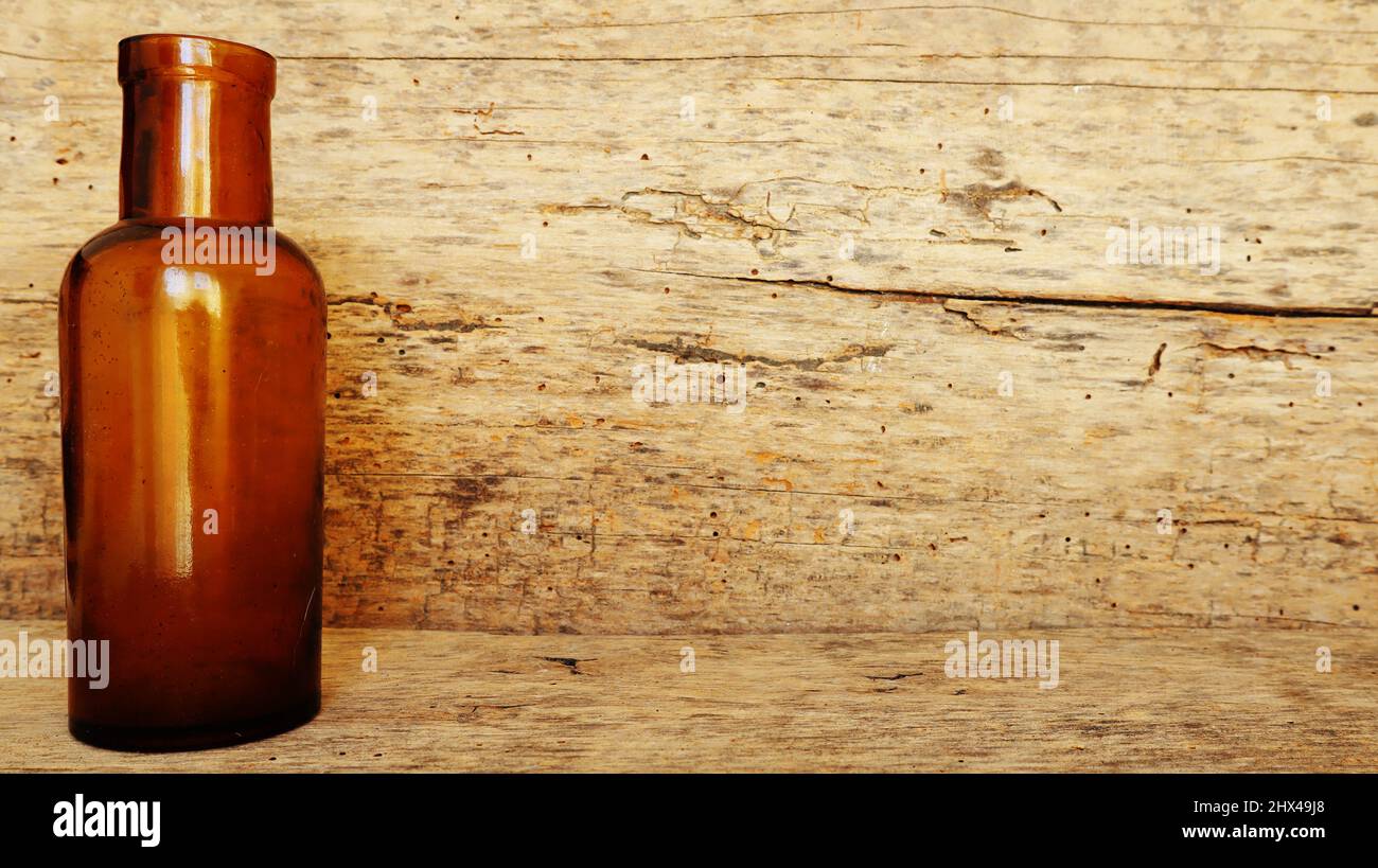 Antique Medicine Bottle, Victorian Era, on a original 1800s wooden background with space for your text or design Stock Photo