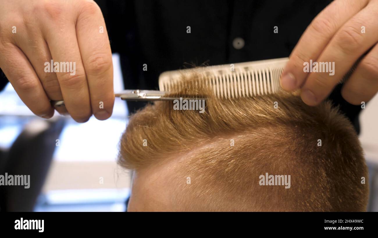 Close up of men's hair cutting scissors in a beauty salon. Master cuts