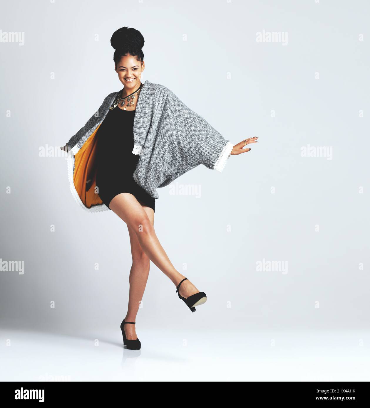 Im an avid follower of fashion. Studio shot of a fashionable young woman posing against a grey background. Stock Photo