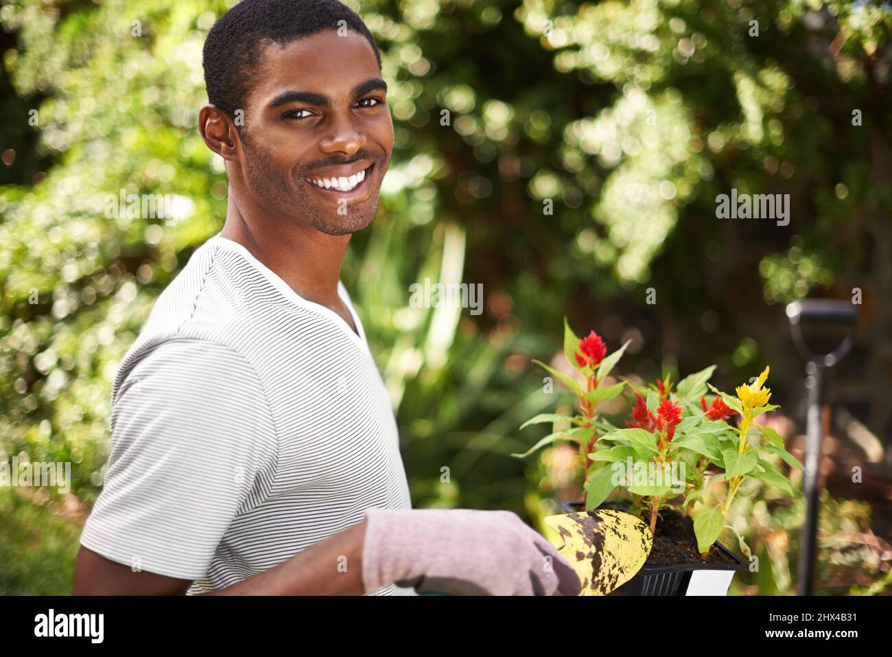 Indulging his green thumb. Portrait of a handsome young man gardening. Stock Photo