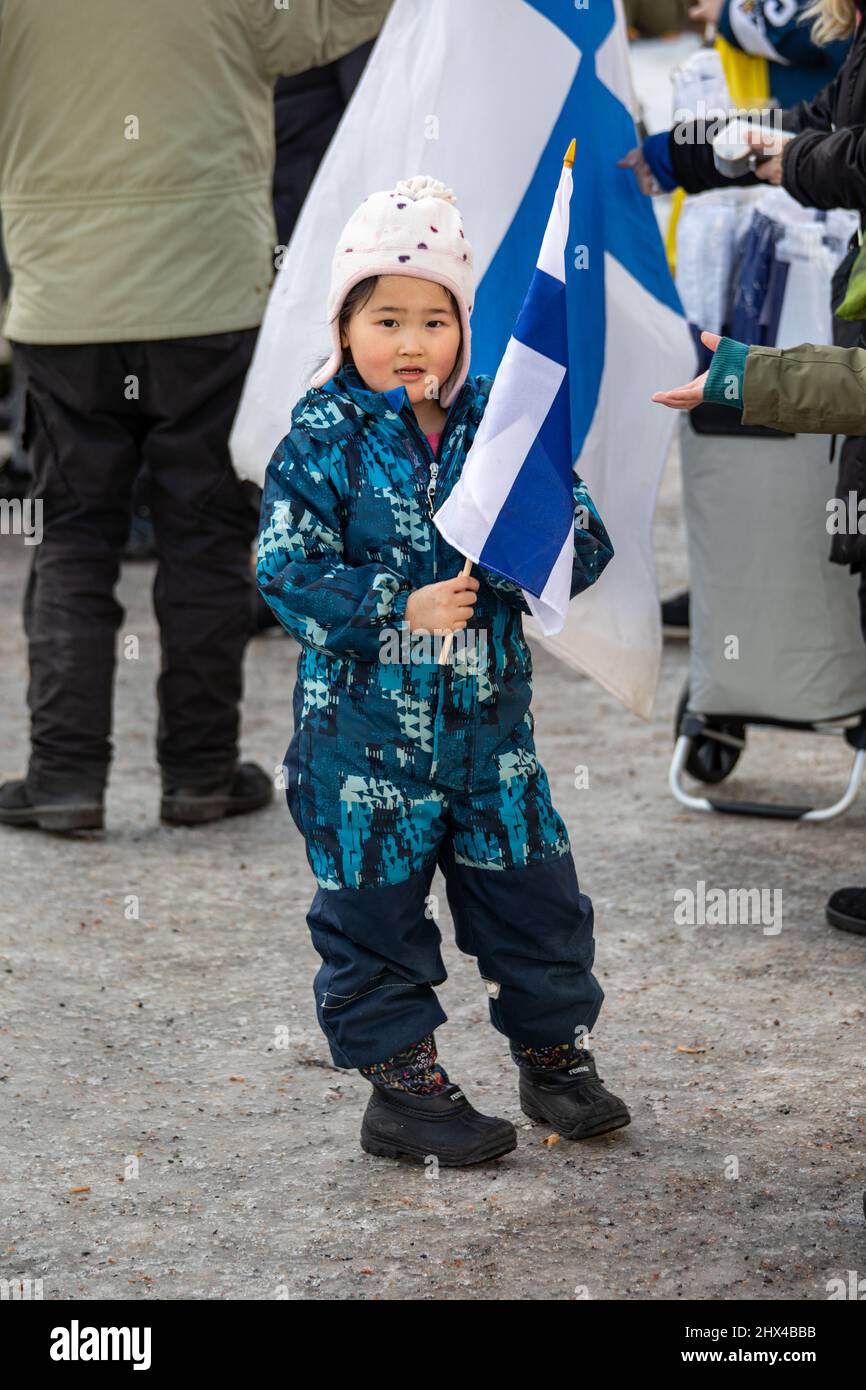 Young girl with flag of Finland on Market Square after men's ice hockey Olympic gold medal in Helsinki, Finland Stock Photo