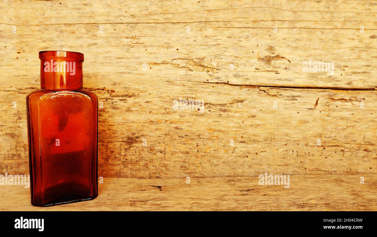 Antique Medicine Bottle, Victorian Era, on a original 1800s wooden background with space for your text or design Stock Photo