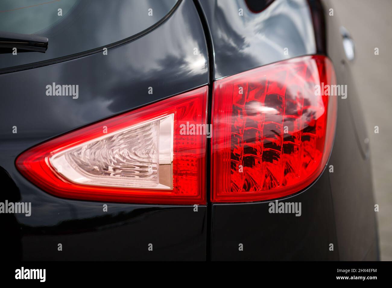 Back view of new black car. Closeup headlights of car. Black premium city  crossover, luxury SUV rear light closeup. Car lamp close-up Stock Photo -  Alamy