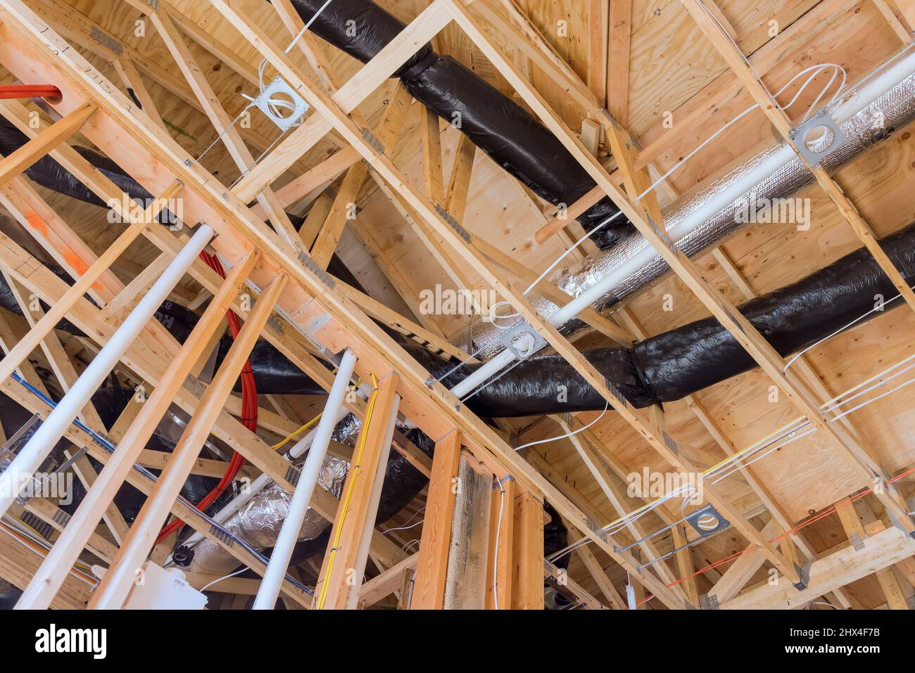 A new building under construction with installation of HVAC tubing vents heating system on the