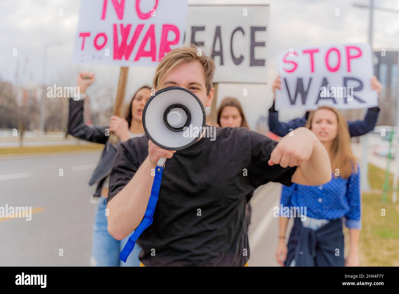 Group of young people are protesting together outside Stock Photo - Alamy