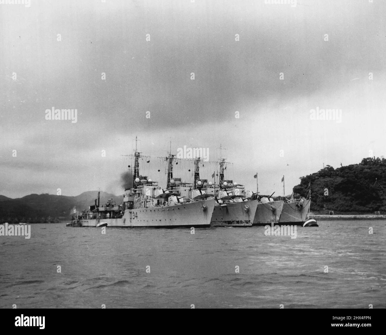 Royal Navy Destroyers Take A Breather - His Majesty's Ships COCKDE, CHARITY, CONSTORT and COSSACK take a well earned breather from Korean War duties at U.S. Fleet Activities Yokosuka. The DD's are commanded by Commander John T. Kimpton, RN; Commander John Henley, RN; Commander George B. Rowe, RN, and Capt. Varyl C. Begg, DSC, RN, respectively. Korean action of the vessels includes the invasion of Inchon, the bombardment of Wonsan, ingshore patrol off the east and wet coast and anti-submarine patrol in support of Royal Navy and United States Navy aircraft carriers. August 10, 1951. (Photo by Of Stock Photo