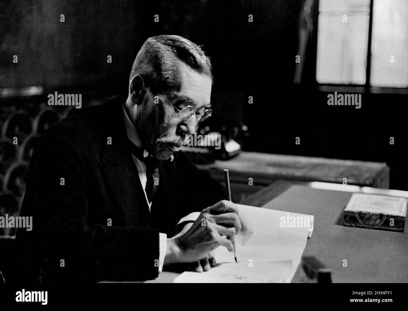 Premier Hiranuma -- The Premier of Japan at his official desk, composing a Japanese letter with a brush. His appointment early in January climaxes a notable official career spanning half a century. Born in 1866, in Okayama Prefecture; he is a graduate of the Law College of Tokyo Imperial University. Starting his career in the Minis-try of Justice as public procurator (prosecutor) in provincial courts, he rose to the directorship of the Board of Criminal Affairs, became Vice-Minister of Justice, was promoted to Procurator General, appointed Chief Justice; and finally Minister of Justice in the Stock Photo