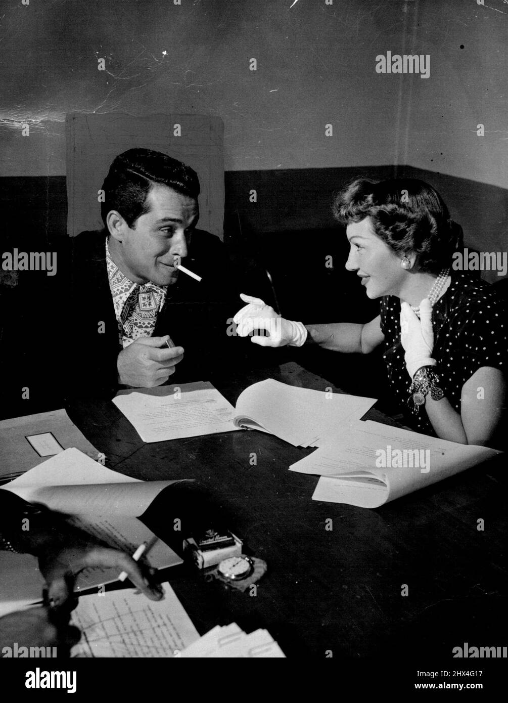 Top Hollywood personalities such as Claudette Colbert (above, with Como) worked as guests on his Super Club show. The acts were tape-recorded in California, Dept on ice until wanted for the show in New York. February 1, 1950. (Photo by Cowles Syndicate). Stock Photo