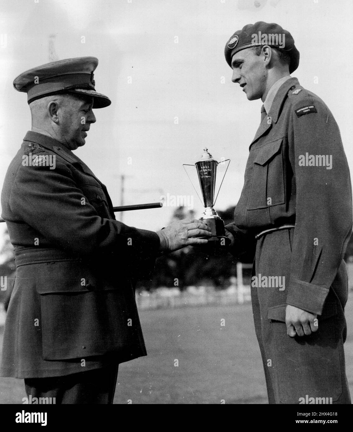 Ceremonial Parade of the Marist brothers high school Darlinghurst this shot shows the Brig F. Hinton. old boy of the school presenting his cup to the winner of the best shooting cadet in the school Corp. Cadet Lt. R. Byrne of Darlinghurst at the Rushcutter bay oval during the passing out parade. October 9, 1952. (Photo by Gordon Herbert Short/Fairfax Media). Stock Photo