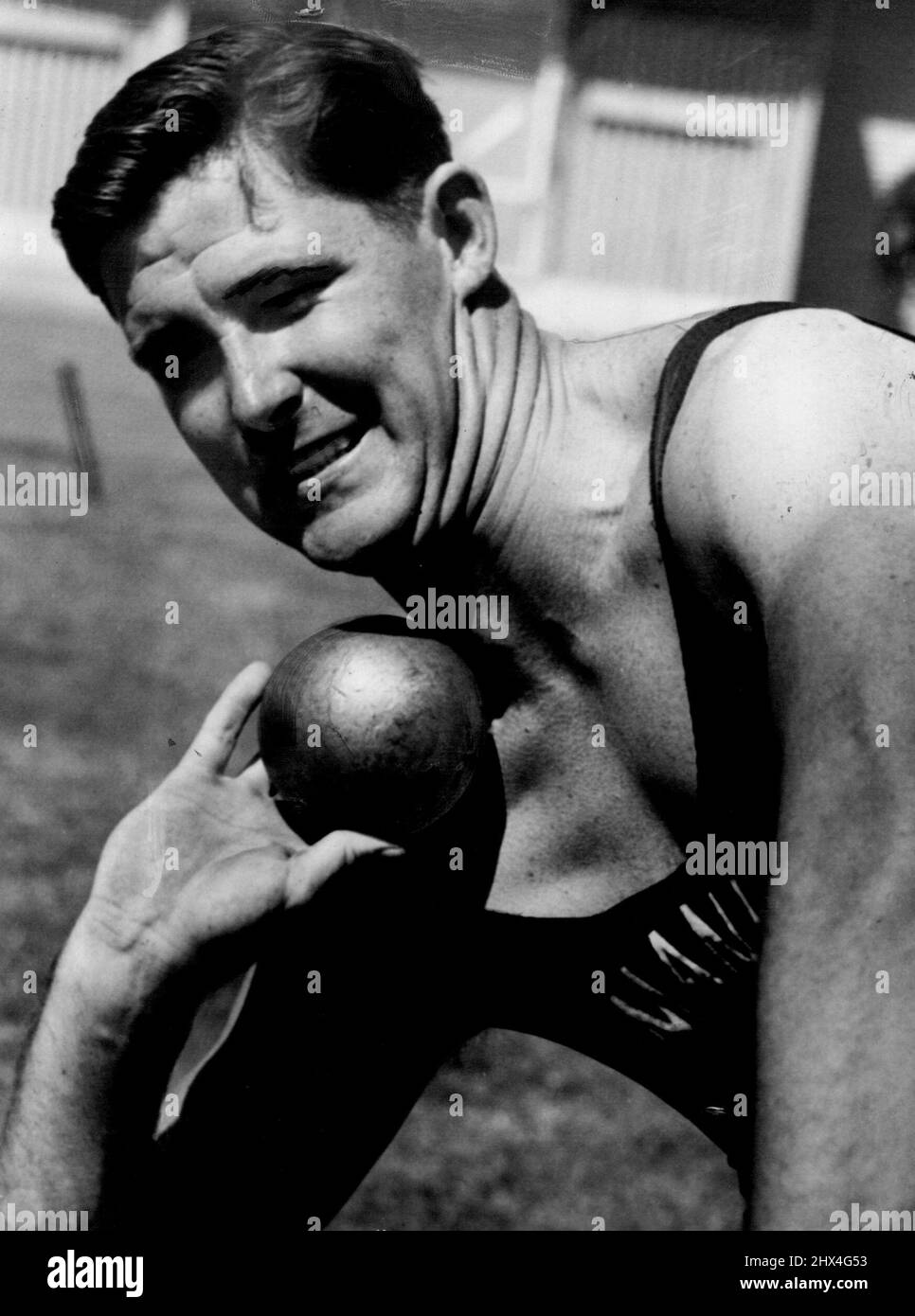 NSW Champion and record holder Peter Hanlin (Manly) in training to defend his shot - put time at Moor title at Moore Park under track on Saturday. January 18, 1954. Stock Photo