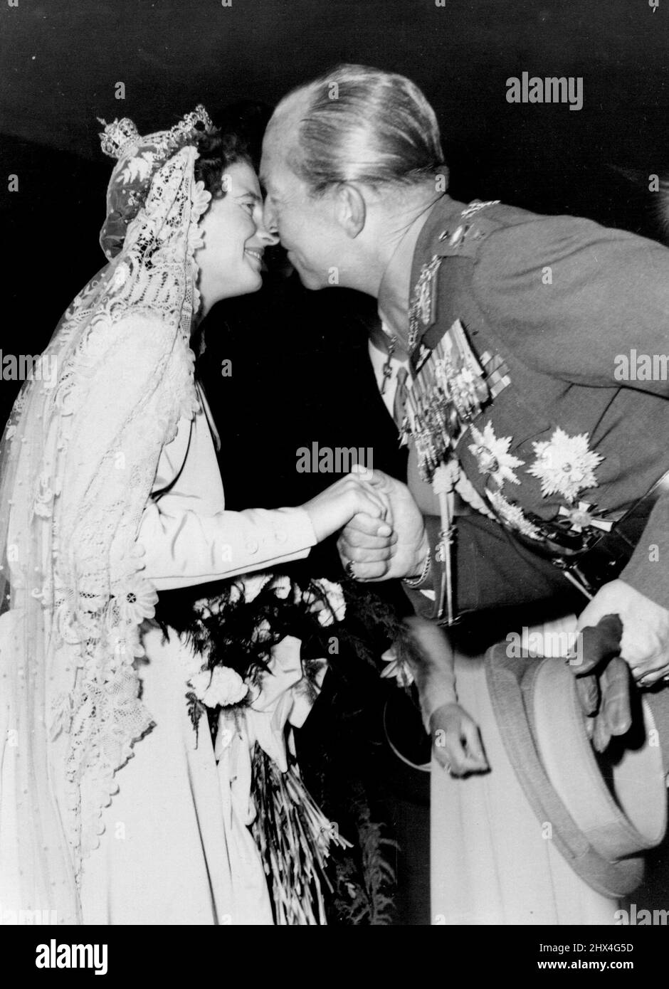 Kiss From A King - King Paul of Greece Kisses the bride at the reception at Schloss Hellenhausen after the ceremony. Wearing the wedding veil of the last German Emoress, Princess Ortrud Von Glueckburg - who married Prince Ernest August Von Hanover at Marienburg Castle in a civil ceremony last week - went through the church ceremony with her husband here. The King and Queen of Greece were guests at the ceremony at the bomb-damaged market church. September 6, 1951. Stock Photo