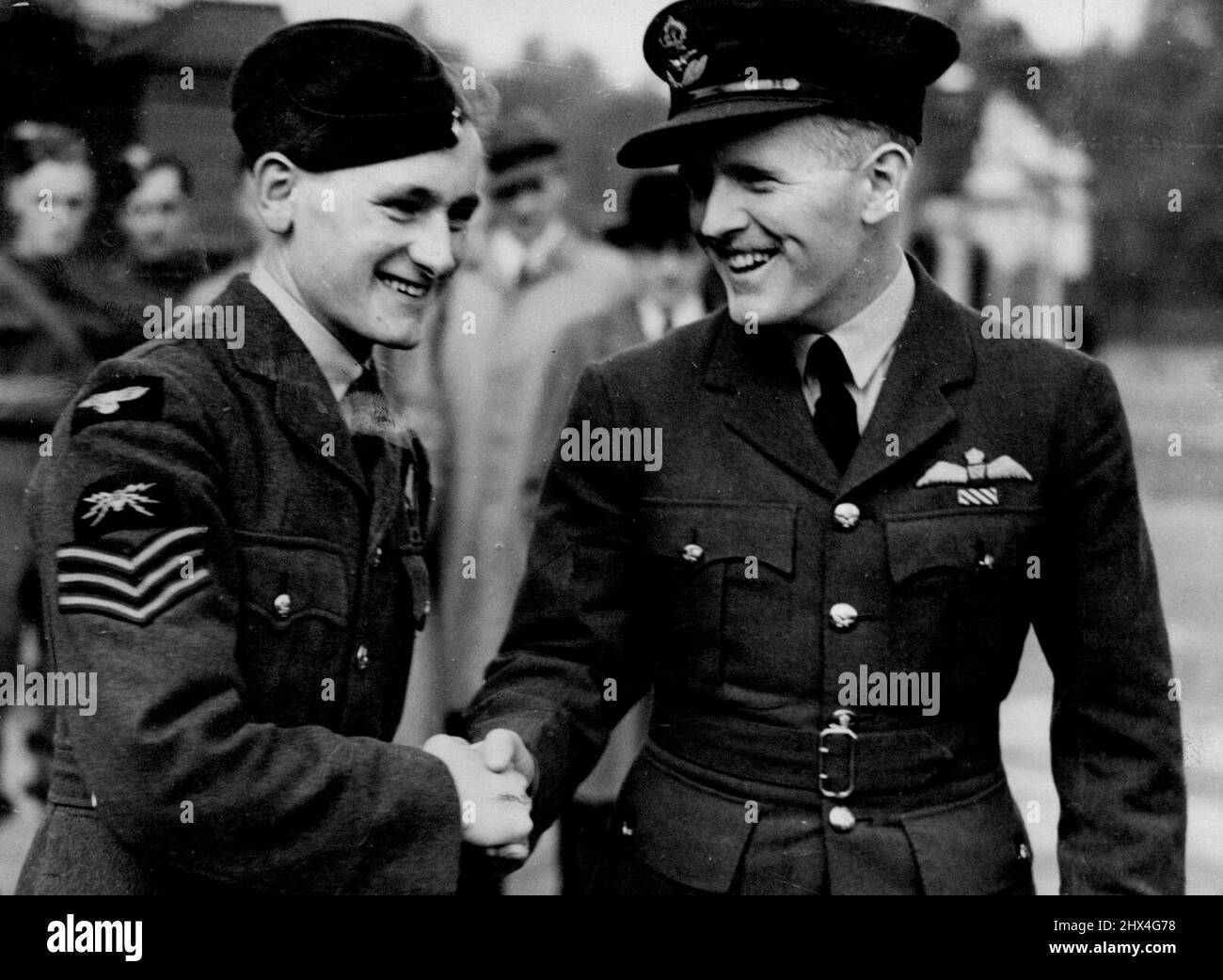 Sergeant Hannah V.C. being congratulated by his pilot, pilot officer C.A. Conner, who was decorated with the D.F.C. outside the palace to-day. ***** Britain's youngest V.C.awarded his decoration for putting out a fire in a blazing aircraft was decorated by the King at Buckingham Palace to-day. Just out of hospital, recovering from extensive burns, Hannah had arrived home expecting three weeks leave. Instead he was recalled to London, and arrived here from Glasgow early this morning. October 10, 1940. Stock Photo