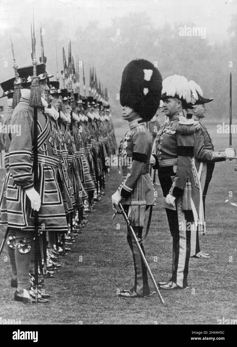 Official Photograph. The King Inspects Yeomen of the Guard in the grounds of Buckingham place. This is the First time for many years that the Reigning sovereign has inspected this ancient body of Men. H.M. King Edward VIII inspecting the King's Bodyguard of the Yeomen of the Guard seen in their picturesque uniform. June 26, 1936. (Photo by Sport & General Press Agency, Limited). Stock Photo